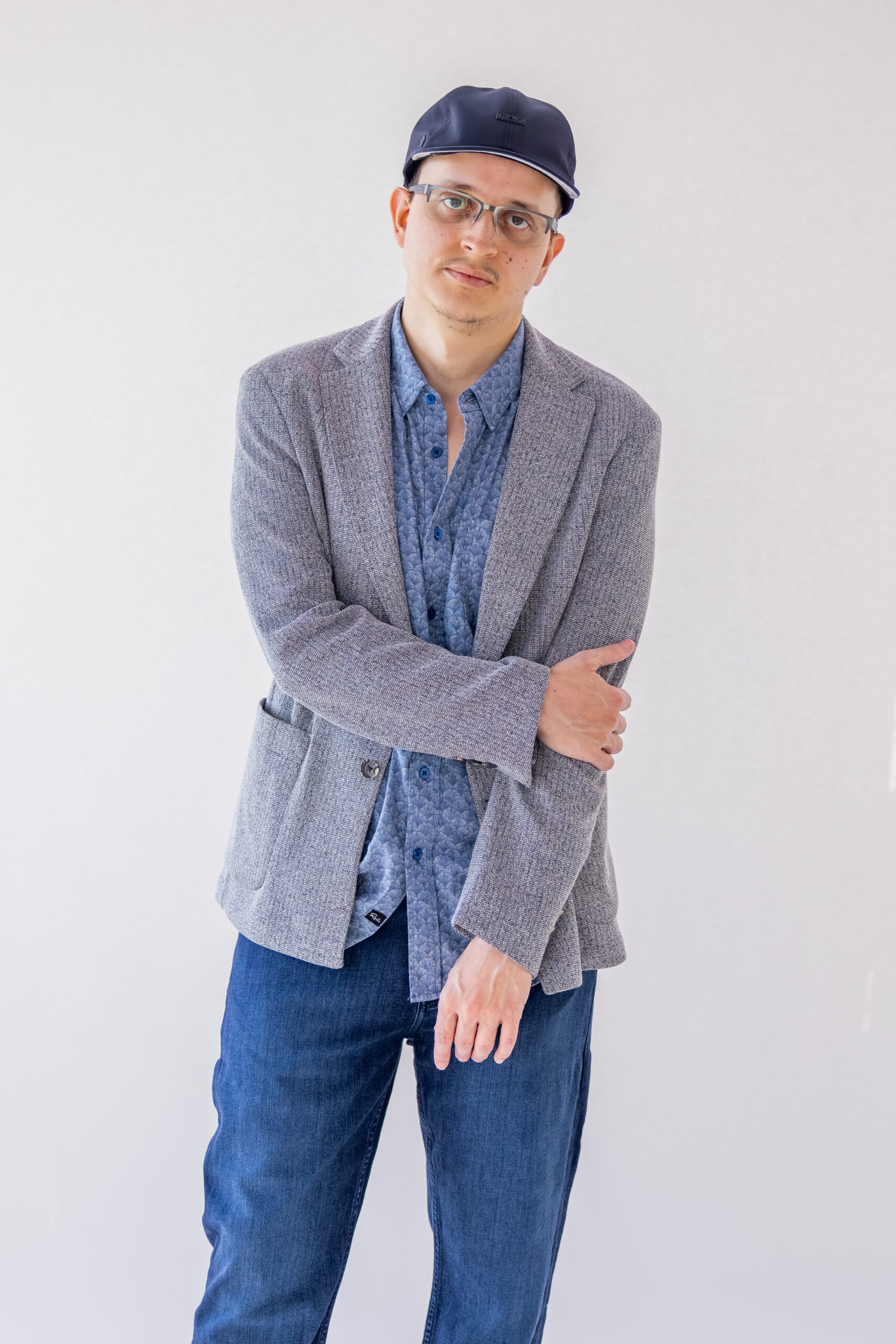 Man wearing a patterned blue shirt and jeans.